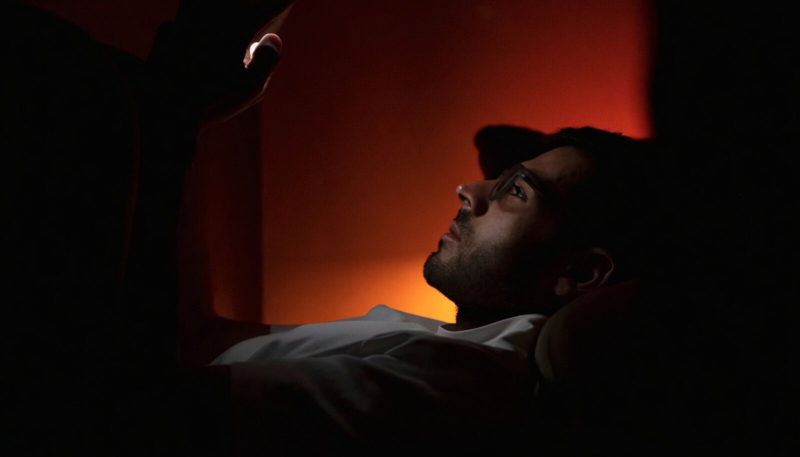 Man at night considering whether to take a porn addiction self-test